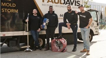 Paul Davis Restoration of West Orange County, CA team standing beside a restoration truck with equipment